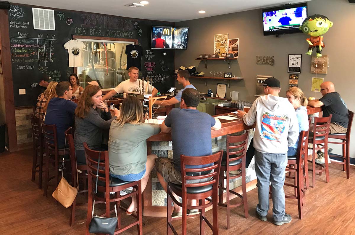 Picture of the old bayheads taproom with patrons sitting around the bar.